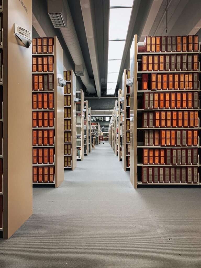 brown wooden book shelves on gray concrete floor